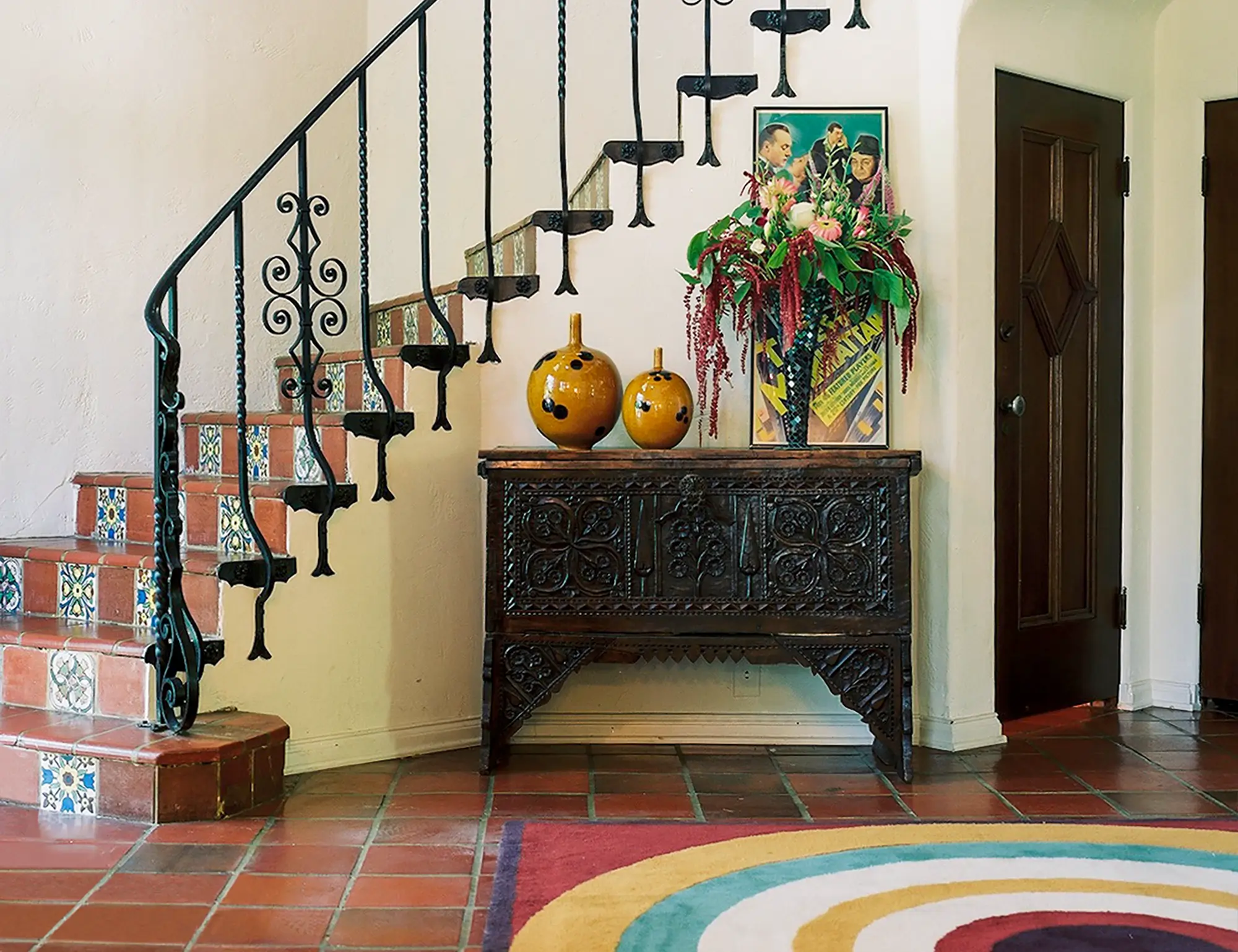 The entry way of an impressive Spanish Revival home showing a mix of period-accurate & modern design details